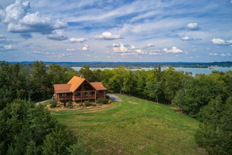 Drone exterior showing the cabin and the lake at Cedar Creeks, a 2bedroom cabin rental located near Douglas Lake