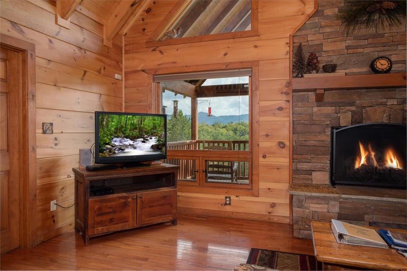 Living room with a television, fireplace, and mountain views at Cedar Creeks, a 2bedroom cabin rental located near Douglas Lake