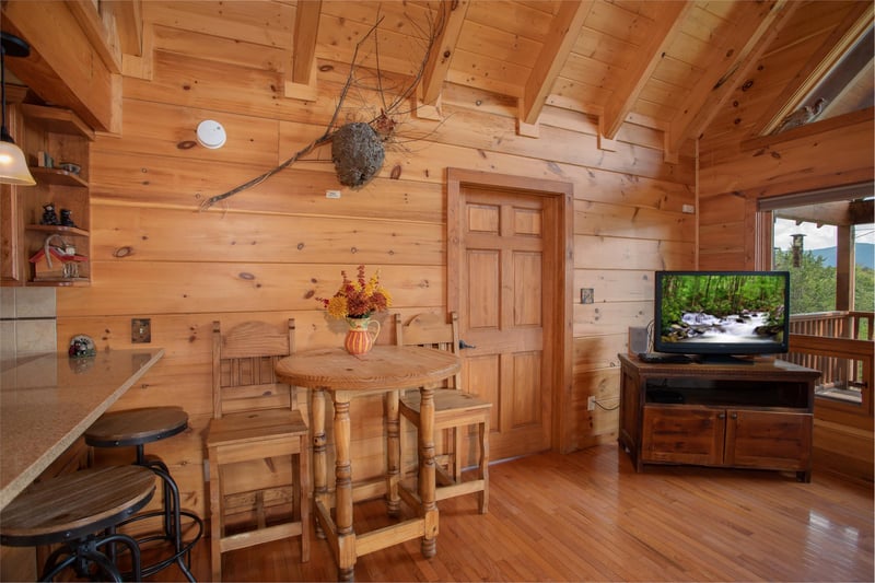 Dining space shared with the living room at Cedar Creeks, a 2bedroom cabin rental located near Douglas Lake