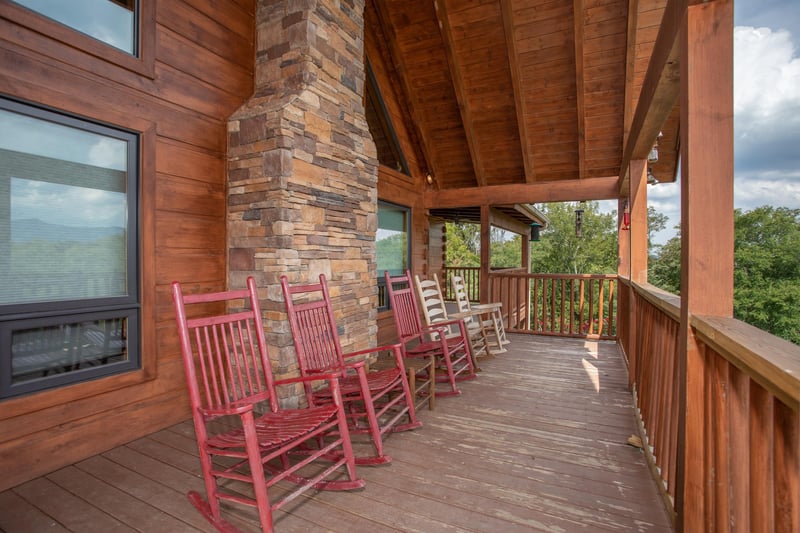 Rocking chairs on a covered deck at Cedar Creeks, a 2bedroom cabin rental located near Douglas Lake