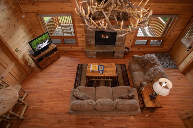 Living room and antler chandelier from above at Cedar Creeks, a 2bedroom cabin rental located near Douglas Lake