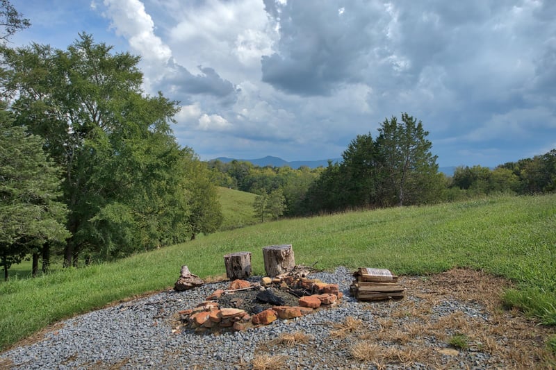 Fire pit in the yard at Cedar Creeks, a 2bedroom cabin rental located near Douglas Lake