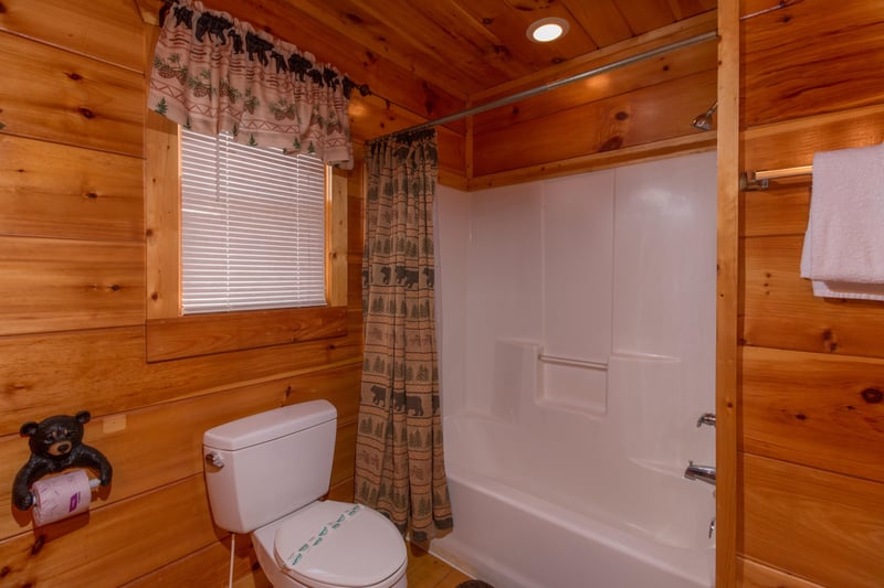 Bathroom with a tub and shower at Moonshine Memories, a 2 bedroom cabin rental located in Gatlinburg