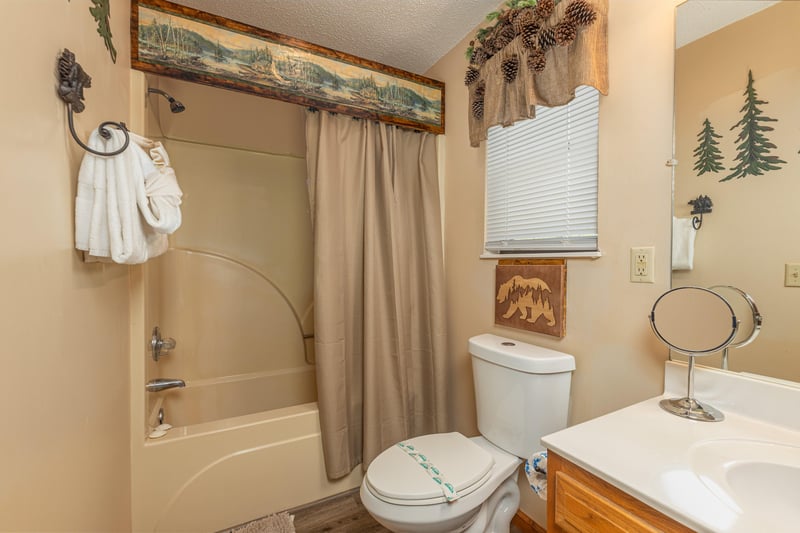 Bathroom with a tub and shower at Magic Moments, a 2 bedroom cabin rental located in Pigeon Forge