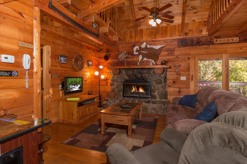 Fireplace and TV in the living room at Hawks Nest, a 1 bedroom cabin rental located in Pigeon Forge