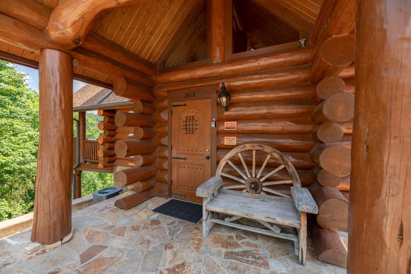 Front door and bench on the porch at Gods Country, a 4 bedroom cabin rental located in Pigeon Forge