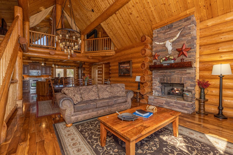 Sofa and fireplace in the living room at Gods Country, a 4 bedroom cabin rental located in Pigeon Forge