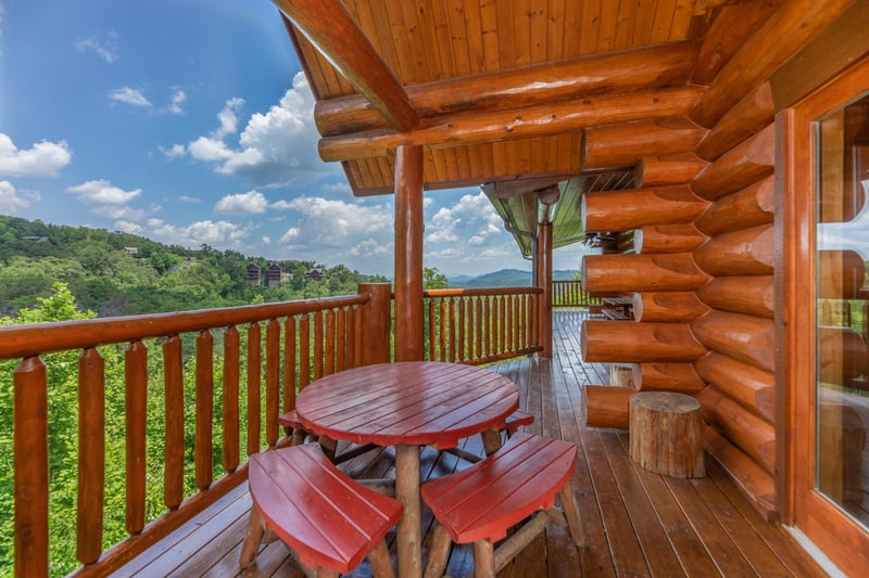 Dining space for four on the deck at Gods Country, a 4 bedroom cabin rental located in Pigeon Forge