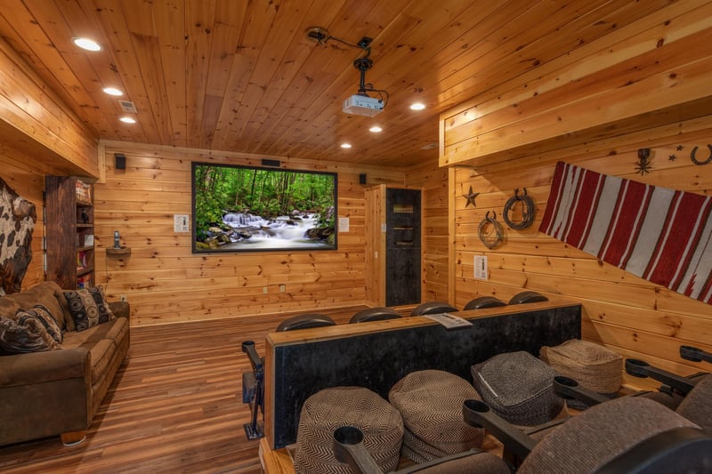 Theater room with a large screen at Gods Country, a 4 bedroom cabin rental located in Pigeon Forge