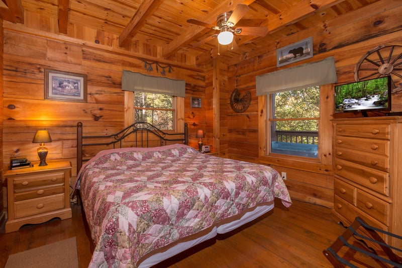 Bedroom with a king bed, night stands, and lamps at Hawks Nest, a 1 bedroom cabin rental located in Pigeon Forge