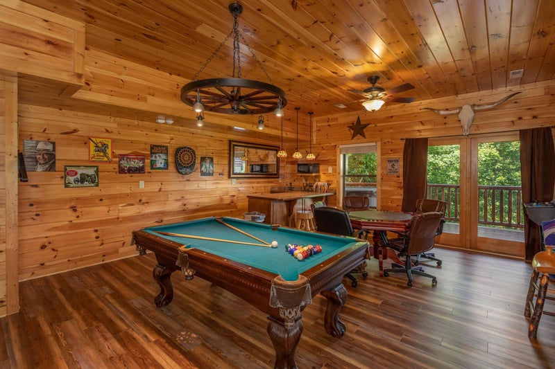 Game room with a green felt pool table and poker table at Gods Country, a 4 bedroom cabin rental located in Pigeon Forge