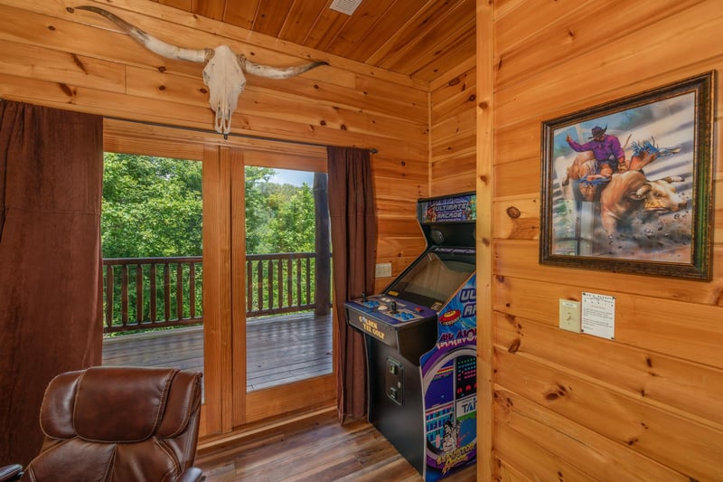 Arcade game in the game room at Gods Country, a 4 bedroom cabin rental located in Pigeon Forge