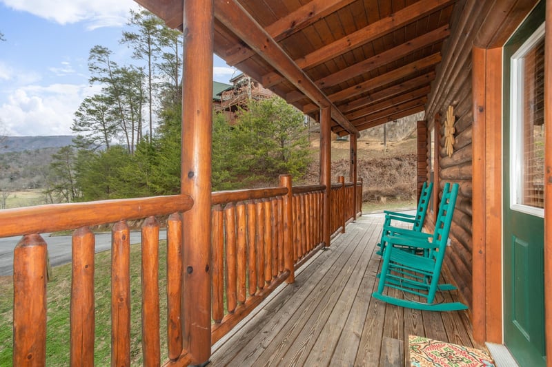 Covered front porch with rocking chairs at Let the Good Times Roll, a 2 bedroom cabin rental located in Pigeon Forge