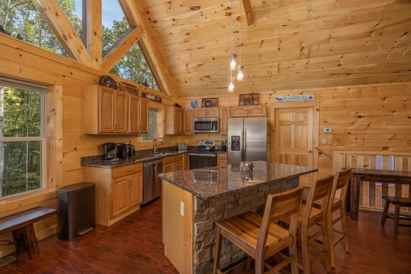 Breakfast bar, dining space, and kitchen at Gar Bears Hideaway, a 3 bedroom cabin rental located in Pigeon Forge