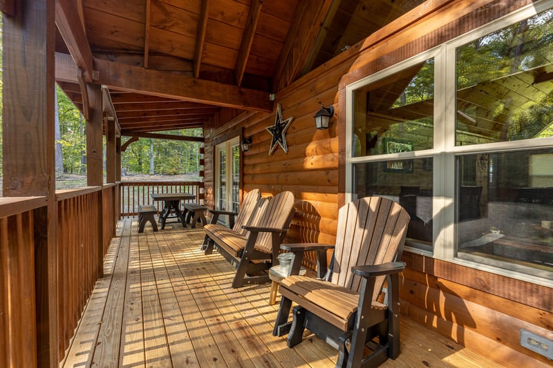 Deck with picnic table and chairs at Gar Bears Hideaway, a Pigeon Forge cabin rental