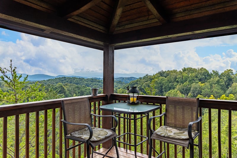 Deck table and chairs for two at Eagles Nest, a 2bedroom cabin rental located in Sevierville