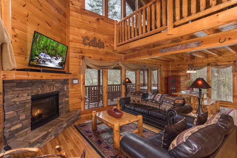 Living room with fireplace and TV at Mountain View Meadows, a 3 bedroom cabin rental located in Pigeon Forge