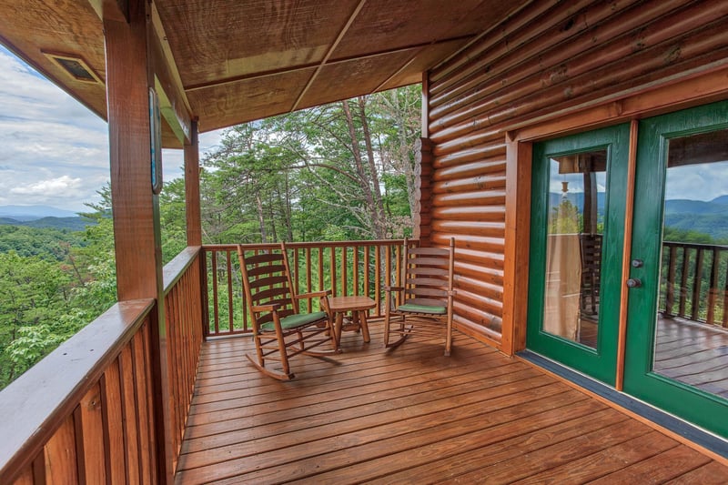 Rocking chairs on the covered deck at I Do Love Views, a 3 bedroom cabin rental located in Pigeon Forge