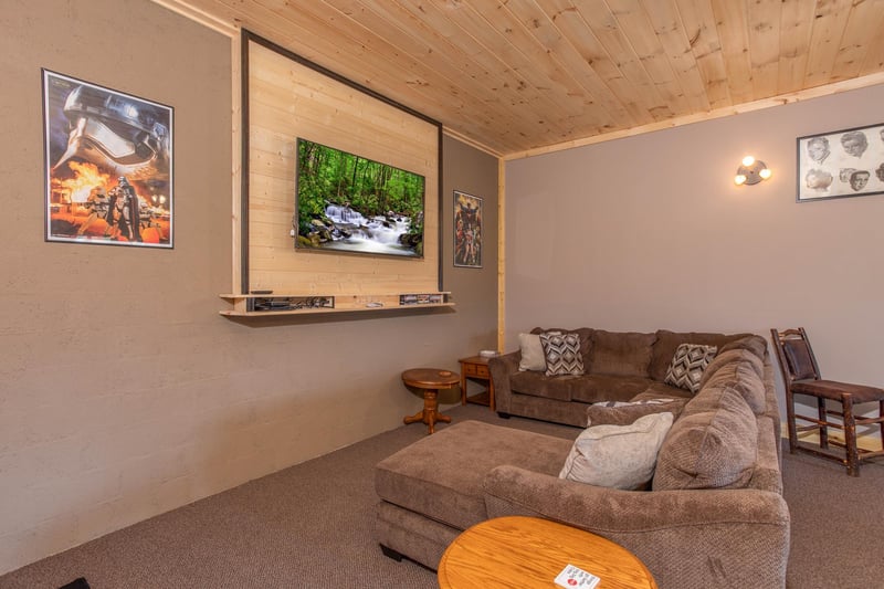 Television and large sectional sofa in the game room at I Do Love Views, a 3 bedroom cabin rental located in Pigeon Forge