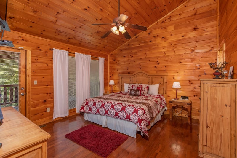 Bedroom with a kingsized bed and two end tables at Cabin Fever, a 4bedroom cabin rental located in Pigeon Forge