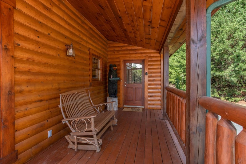 Gliding loveseat on the covered deck at Cabin Fever, a 4bedroom cabin rental located in Pigeon Forge