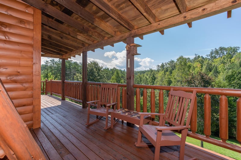 Rocking chairs on a covered deck at Cabin Fever, a 4bedroom cabin rental located in Pigeon Forge