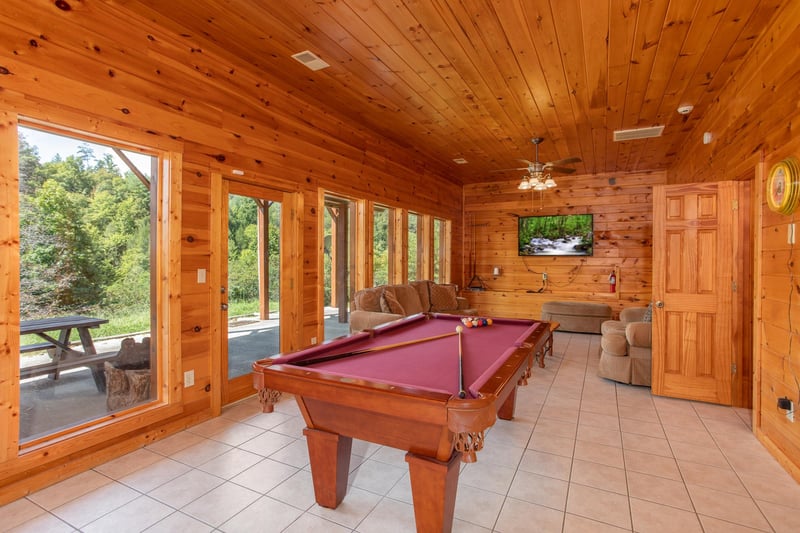 Red felted pool table in a game room at Cabin Fever, a 4bedroom cabin rental located in Pigeon Forge