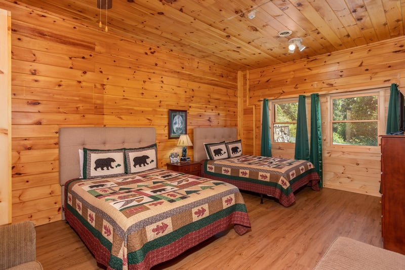 Two queen beds with tufted headboards at Cabin Fever, a 4bedroom cabin rental located in Pigeon Forge