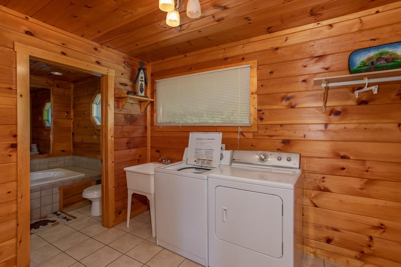 Laundry room with a utility sink, washer, and dryer at Cabin Fever, a 4bedroom cabin rental located in Pigeon Forge