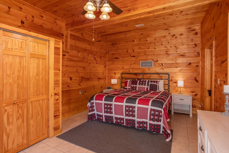 Queen bed with two end tables at Cabin Fever, a 4bedroom cabin rental located in Pigeon Forge