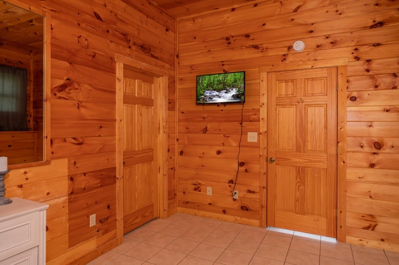 Wall mounted tv in a bedroom at Cabin Fever, a 4bedroom cabin rental located in Pigeon Forge