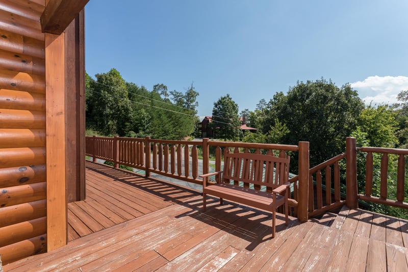 Bench on the deck next to the stairs at Cabin Fever, a 4bedroom cabin rental located in Pigeon Forge