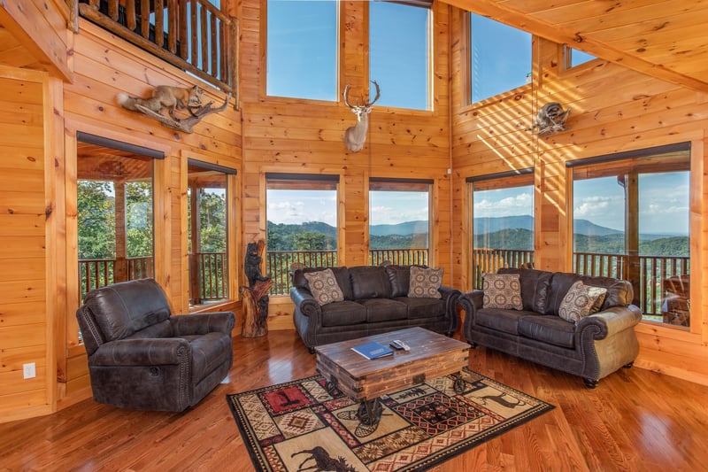 Floor to ceiling windows in a vaulted living room at Four Seasons Palace, a 5bedroom cabin rental located in Pigeon Forge