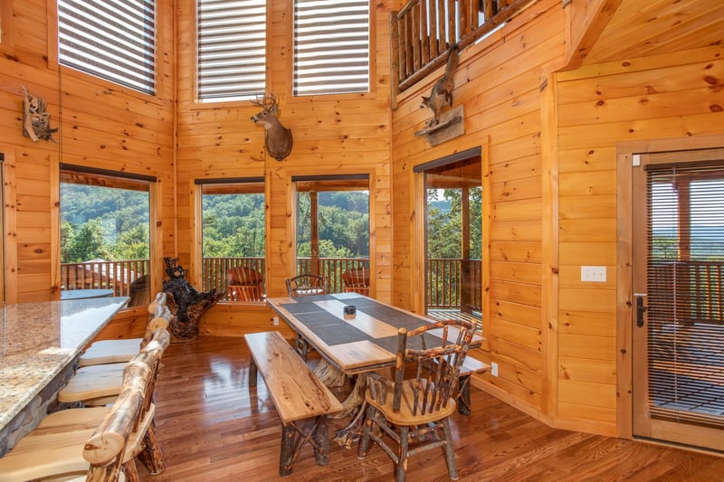 Dining space at the kitchen counter and a large table at Four Seasons Palace, a 5bedroom cabin rental located in Pigeon Forge