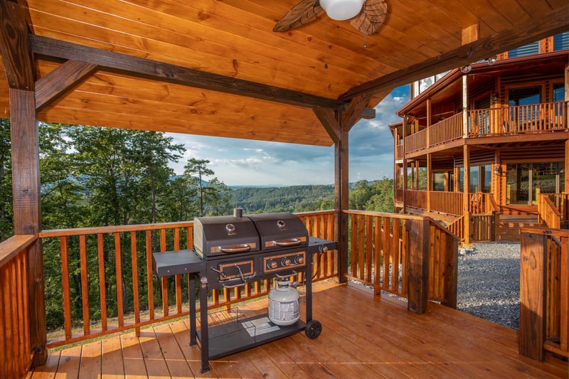 Propane grill on a covered deck at Four Seasons Palace, a 5bedroom cabin rental located in Pigeon Forge