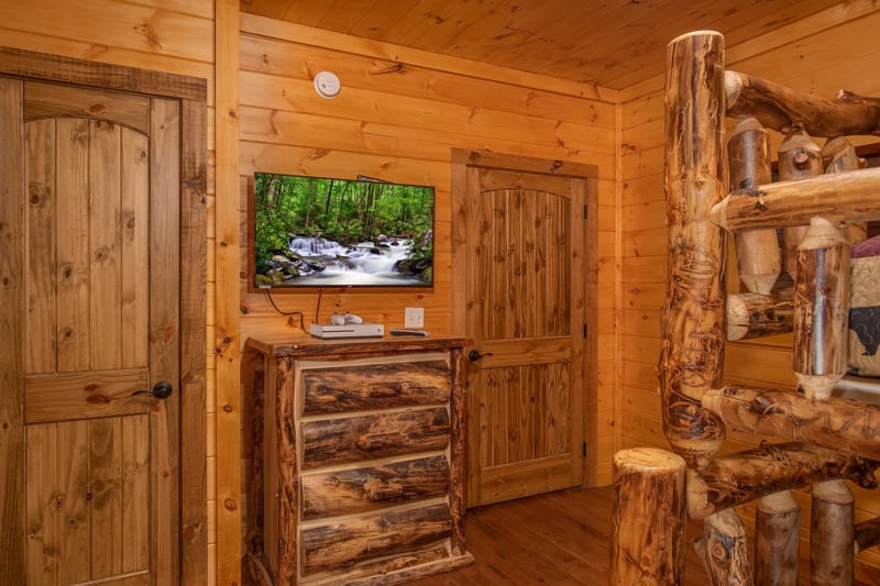 Bunk room with a dresser and TV at Four Seasons Palace, a 5bedroom cabin rental located in Pigeon Forge