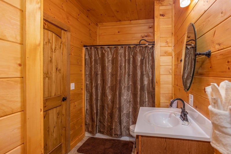 Bathroom with a tub and shower at Four Seasons Palace, a 5bedroom cabin rental located in Pigeon Forge