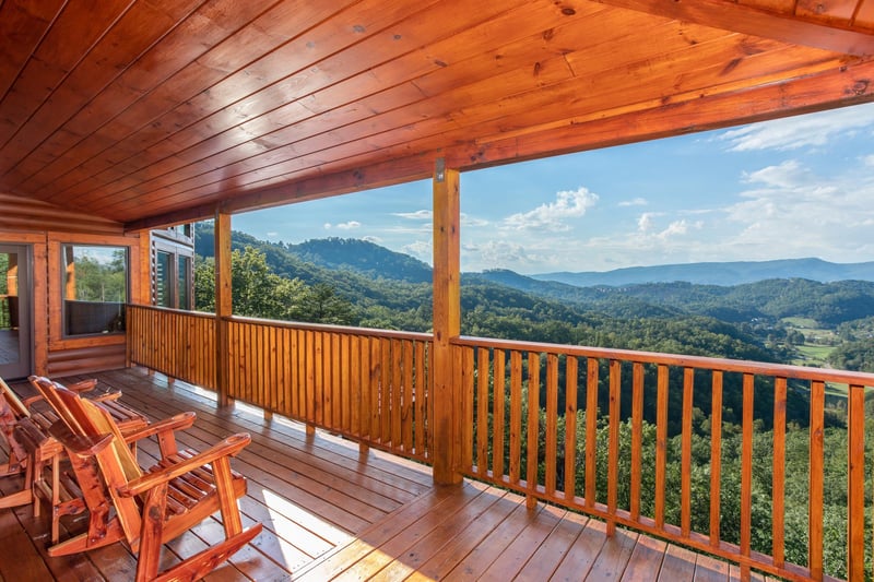 Rocking chairs on the deck overlooking the mountains at Four Seasons Palace, a 5bedroom cabin rental located in Pigeon Forge