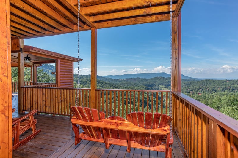 Adirondack style porch swing overlooking the views at Four Seasons Palace, a 5bedroom cabin rental located in Pigeon Forge