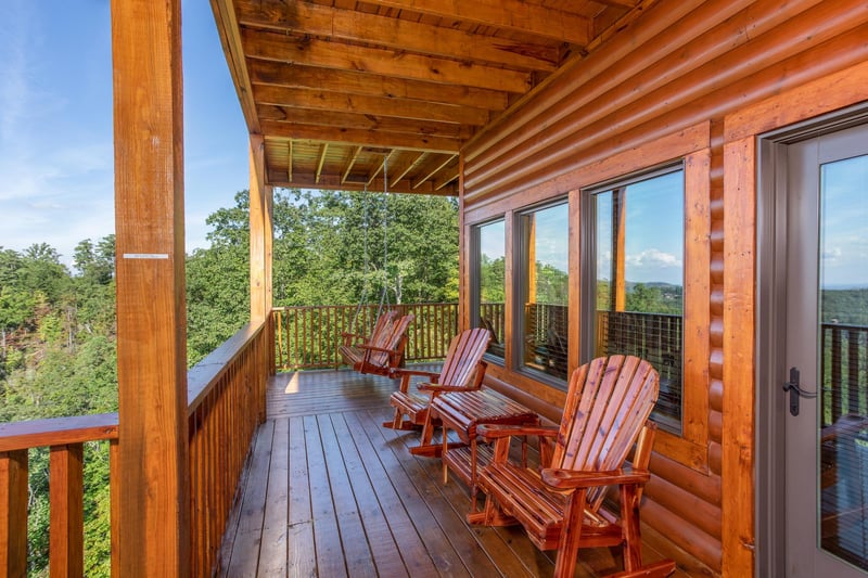 Gliding chairs on the porch at Four Seasons Palace, a 5bedroom cabin rental located in Pigeon Forge