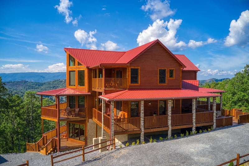 Looking at the plentiful parking and cabin exterior at Four Seasons Palace, a 5bedroom cabin rental located in Pigeon Forge