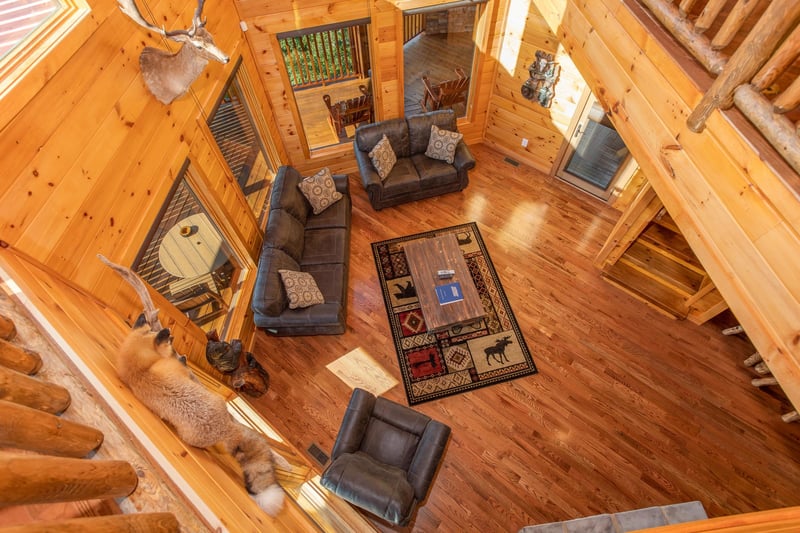 Sofa, loveseat, and chair in the living room as viewed from the upper floor at Four Seasons Palace, a 5bedroom cabin rental located in Pigeon Forge