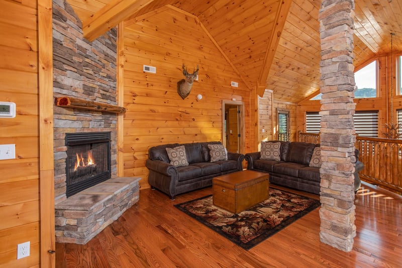 Upper living room with a fireplace and plenty of seating at Four Seasons Palace, a 5bedroom cabin rental located in Pigeon Forge