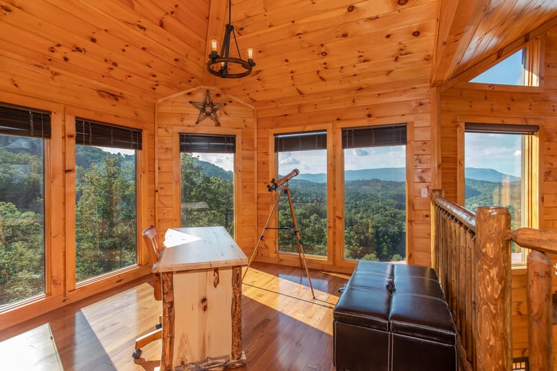 Loft space with a desk and telescope at Four Seasons Palace, a 5bedroom cabin rental located in Pigeon Forge