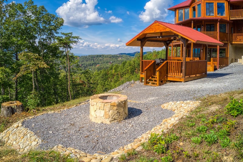 Fire pit in the picnic area at Four Seasons Palace, a 5bedroom cabin rental located in Pigeon Forge