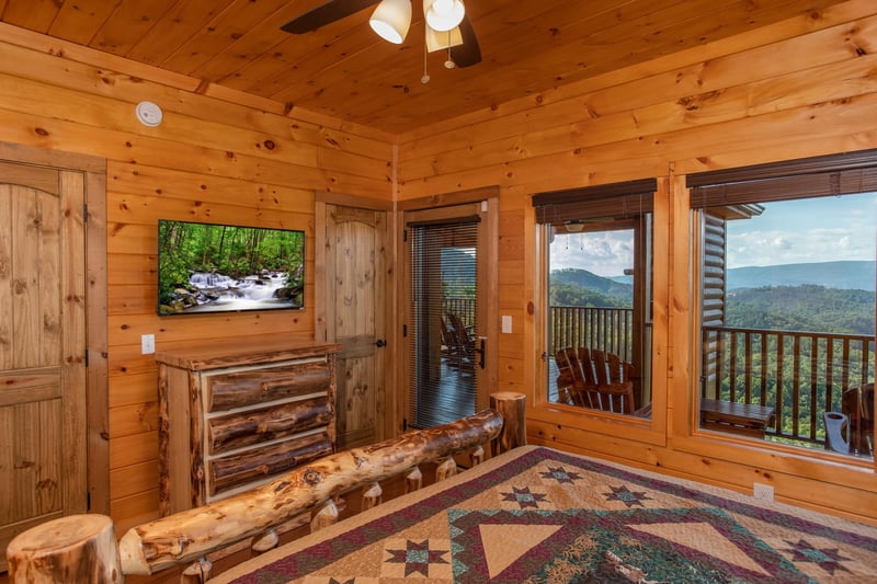 Bedroom with a dresser, TV, deck access, and mountain views at Four Seasons Palace, a 5bedroom cabin rental located in Pigeon Forge