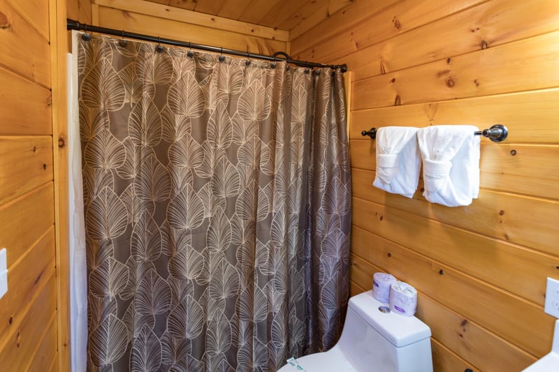 Bathroom with a tub and shower at Four Seasons Palace, a 5bedroom cabin rental located in Pigeon Forge