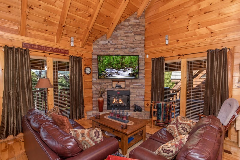 Living room stone fireplace and television at Bears Eye View, a 2bedroom cabin rental located in Pigeon Forge