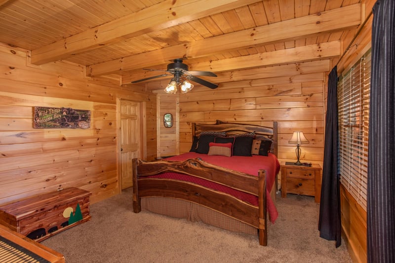 Kingsized log bed in a bedroom at Bears Eye View, a 2bedroom cabin rental located in Pigeon Forge