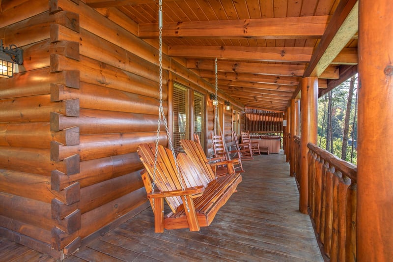 Porch swing on a covered deck at Bears Eye View, a 2bedroom cabin rental located in Pigeon Forge